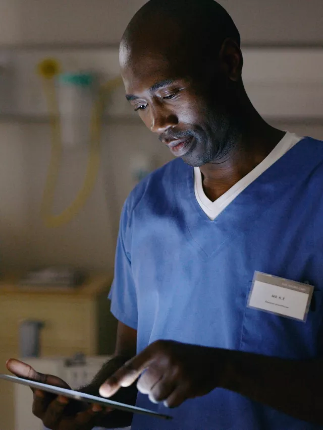 man in hospital with tablet