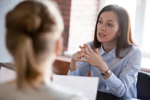 women talking over business