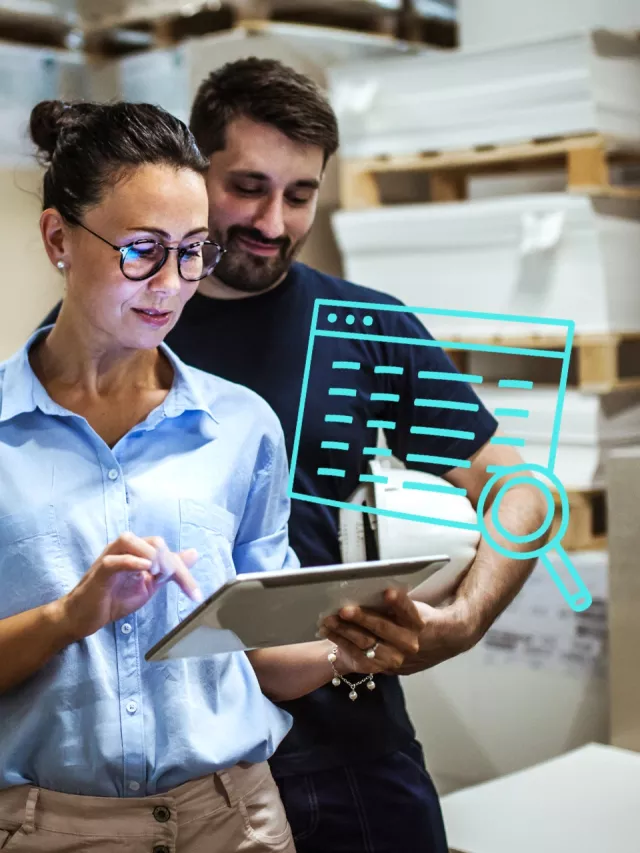 Woman and man looking up data in spreadsheet